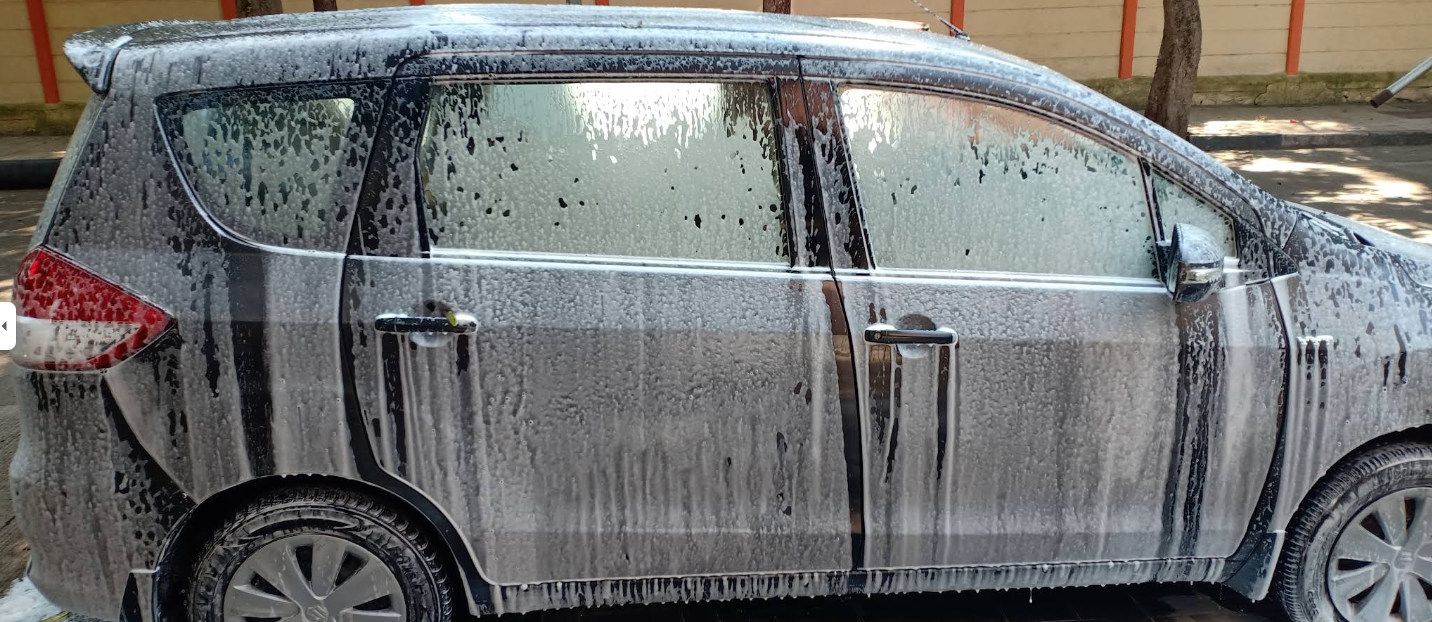Car covered in thick foam during a wash at Pyramid Washing Center